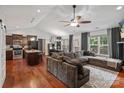 Open concept living room boasts hardwood floors, a vaulted ceiling, and a sectional sofa at 1774 Timmons Marie Ln, Lincolnton, NC 28092