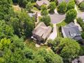 Aerial view of a home surrounded by lush trees and a well-maintained yard at 2103 Lytton Ln, Matthews, NC 28104
