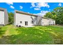 Spacious backyard with a lush green lawn and a small patio area, perfect for outdoor relaxation at 2316 Savannah Hills Dr, Matthews, NC 28105