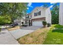 Charming two-story home featuring vinyl siding, brick accents, and an attached two-car garage at 2316 Savannah Hills Dr, Matthews, NC 28105