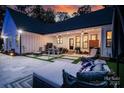 Outdoor living space featuring a covered patio with ceiling fans, outdoor kitchen, and comfortable seating, perfect for relaxing at 2418 Shuford Rd, Lincolnton, NC 28092