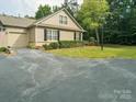Inviting home showcasing a large driveway, attached garage, and meticulously kept lawn at 2656 Polo Club Blvd, Matthews, NC 28105