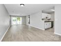 Open-concept living area with a sliding glass door and eat-in kitchen at 3853 Carl Parmer Dr, Harrisburg, NC 28075