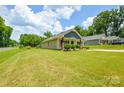 Charming one-story home with a well-maintained lawn, showcasing curb appeal at 551 Sylvan Sw St, Concord, NC 28025