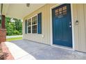 Inviting front door entrance with brick supports and blue shutters, offering a warm welcome at 551 Sylvan Sw St, Concord, NC 28025