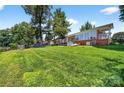 Expansive backyard with lush green lawn and lake views and the patio outside the back of the house at 622 S Carolina Ave, Statesville, NC 28677