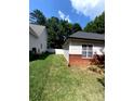 The well-maintained backyard features green grass and a white fence for a private outdoor space at 7333 Rosehall Dr, Charlotte, NC 28227