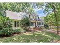 Inviting home with dormer windows surrounded by lush landscaping and a well-manicured lawn at 8500 Peyton Randolph Dr, Charlotte, NC 28277