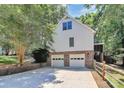 Rear of home with two-car garage, screened-in porch and well maintained fencing and landscaping at 8500 Peyton Randolph Dr, Charlotte, NC 28277