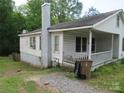 Side view of charming home featuring a large chimney and a welcoming porch at 1146 Buffalo St, Shelby, NC 28150