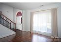 Bright living room featuring gleaming wood floors and abundant natural light through large windows at 12520 Vantage Point Ln, Huntersville, NC 28078