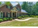 Charming brick home featuring a classic design, well-manicured lawn and dark shutters at 1503 Jack White Dr, Rock Hill, SC 29732