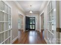Bright foyer with hardwood floors and a black front door flanked by glass-paned doors at 1503 Jack White Dr, Rock Hill, SC 29732