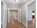Inviting foyer featuring hardwood floors, elegant French doors, and views of the staircase at 1503 Jack White Dr, Rock Hill, SC 29732