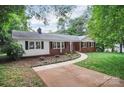 Beautiful red brick home with a walkway and lush landscaping creates great curb appeal at 1538 Hilltop Dr, Shelby, NC 28150