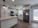 Modern kitchen featuring white cabinets, stainless steel appliances, and granite countertops at 1600 Russell Courtney Rd, Monroe, NC 28112