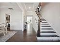 Spacious foyer with hardwood floors, a staircase, and elegant trim details at 19012 Beecher Commons Dr, Huntersville, NC 28078