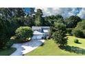 An aerial view of a gray home with a three-car garage on a large lot with mature trees at 2949 Glenstone Dr, Rock Hill, SC 29730