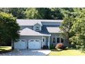 Charming gray home with three-car garage, landscaped yard and inviting front entrance at 2949 Glenstone Dr, Rock Hill, SC 29730