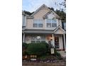 Charming townhome featuring a cozy front porch with landscaping and inviting decorations at 311 Wilkes Place Dr, Fort Mill, SC 29715