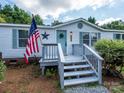 Close-up of the entrance steps to a single-story home with a patriotic American flag on display at 4833 Verde View Dr, Gastonia, NC 28056