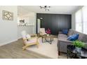 Bright living room with modern decor, wood floors, and comfortable seating arrangement with views to kitchen at 4833 Verde View Dr, Gastonia, NC 28056
