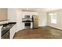 Modern kitchen featuring stainless steel appliances, granite countertops, and ample cabinet space for storage and convenience at 671 Sylvan Sw St, Concord, NC 28025