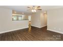 This open-concept living room features dark hardwood floors and a seamless transition to other rooms at 671 Sylvan Sw St, Concord, NC 28025