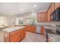 Spacious kitchen with granite countertops, stainless steel appliances, large central island and ample storage at 7362 Waterwheel Sw St, Concord, NC 28025