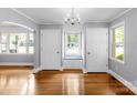 Bright dining room featuring hardwood floors, an elegant chandelier, and a cozy window seat at 810 Lakeview Dr, Pineville, NC 28134