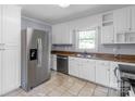 Well-lit kitchen equipped with stainless steel appliances, granite counters, and white cabinetry at 810 Lakeview Dr, Pineville, NC 28134