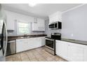 Well-lit kitchen equipped with stainless steel appliances, granite counters, and white cabinetry at 810 Lakeview Dr, Pineville, NC 28134