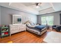 Bright bedroom featuring a tray ceiling, hardwood floors, and a window for natural light at 1274 Winding Path Rd, Clover, SC 29710