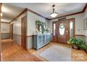 Elegant foyer with hardwood floors, a decorative mirror, and a wooden front door at 1388 Aragon Beach Rd, Rock Hill, SC 29732