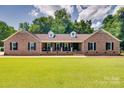 Charming brick home with a manicured lawn, black shutters, and a welcoming front porch at 1388 Aragon Beach Rd, Rock Hill, SC 29732