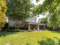 A spacious backyard features a covered patio with lounge furniture, perfect for outdoor living at 13930 Daltrey Ln, Charlotte, NC 28277