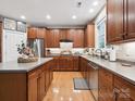 This large kitchen showcases beautiful wood cabinets, stainless steel appliances, and an island at 13930 Daltrey Ln, Charlotte, NC 28277
