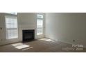 Bright living room featuring a fireplace, carpet, and natural light at 162 Autumn Falls Dr, Lake Wylie, SC 29710