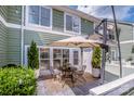 Relaxing patio space with comfortable seating, mature potted plants, and string lights at 17406 Tuscany Ln, Cornelius, NC 28031
