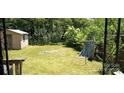 Overgrown backyard with tall grass and greenery at 202 N Dilling St, Kings Mountain, NC 28086