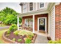Inviting front porch with rocking chairs and beautiful landscaping at 2103 Cantata Ct, Matthews, NC 28105