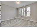 A bright bedroom showcasing modern flooring and shuttered windows at 3018 Trace Meadow Ct # 125, York, SC 29745