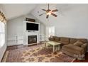 Spacious living room with vaulted ceiling, fireplace, built-in shelves, and hardwood flooring at 317 Sugar Creek Xing, Fort Mill, SC 29715