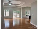 Spacious living room with hardwood floors, tray ceiling, and sliding door to deck at 3837 1St Street Nw Ln, Hickory, NC 28601