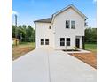 Charming two-story home with white siding, a large driveway, and a manicured lawn at 405 E Broad St, Salisbury, NC 28144