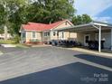 Expansive driveway leading to a charming home with a covered carport and spacious deck at 4303 Grier St, Gastonia, NC 28056