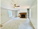Inviting living room with a cozy fireplace, ceiling fan, and plush carpeting at 4832 Gideon Dr, Lincolnton, NC 28092