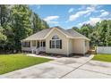 A well-maintained home featuring a cozy front porch, a driveway, and a small wooden deck on the side at 608 Red Hawk Way, Clover, SC 29710