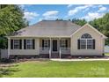 Charming single-story home with a manicured lawn, a welcoming porch, and black shutters at 608 Red Hawk Way, Clover, SC 29710