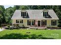 Inviting exterior showcasing a charming home with a cozy front porch and well-kept lawn at 7648 Forest Oak Dr, Denver, NC 28037